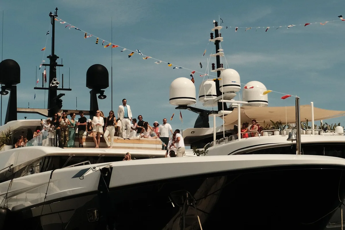 Guests on the top deck of a superyacht in Monaco