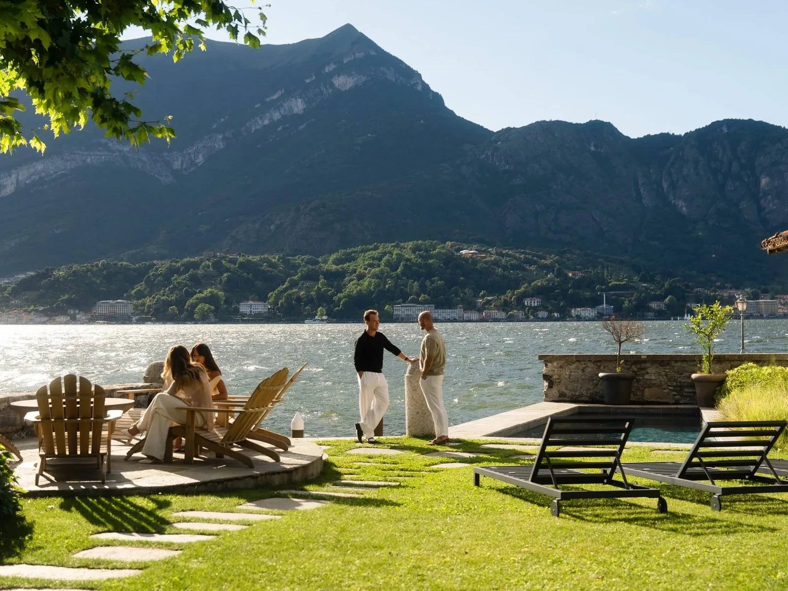 Residents on the lawn of a lakeside residence on Lake Como