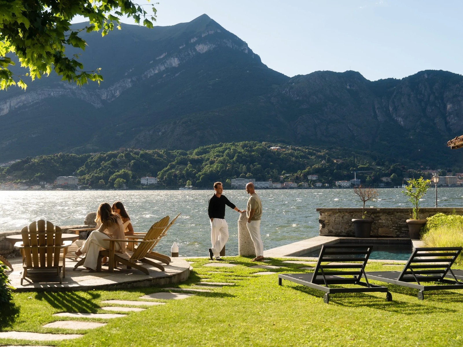 Residents on the lawn of a lakeside residence on Lake Como