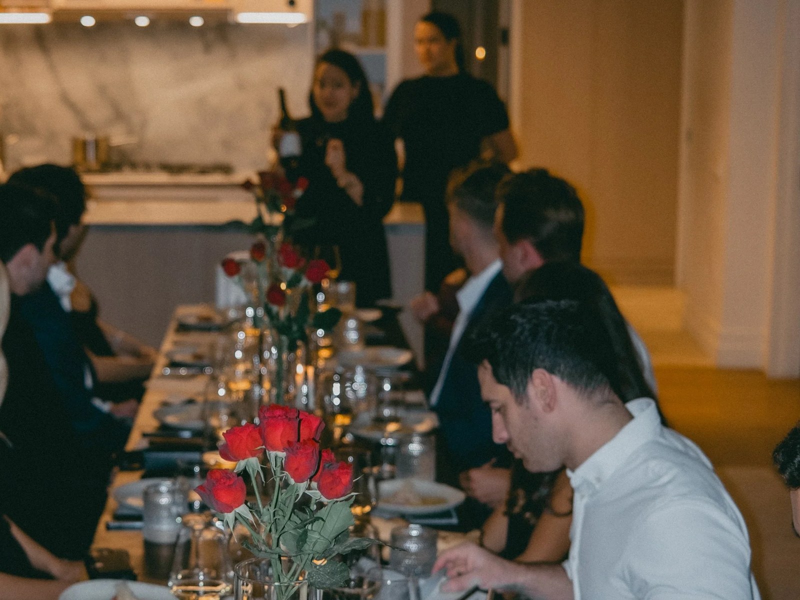 A hosted candlelit client dinner at a long table
