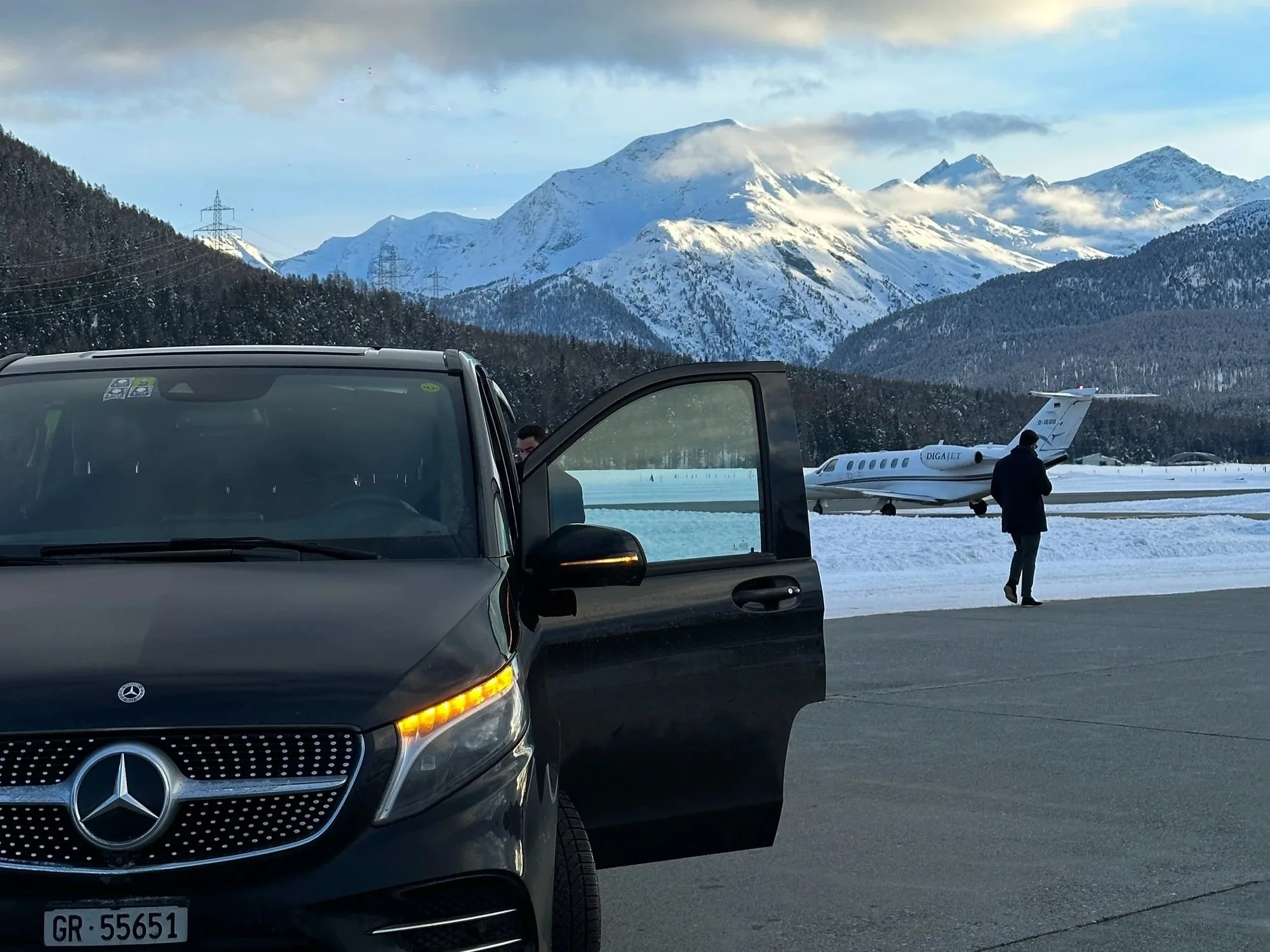 Chauffeured Mercedes V-Class beside a private jet