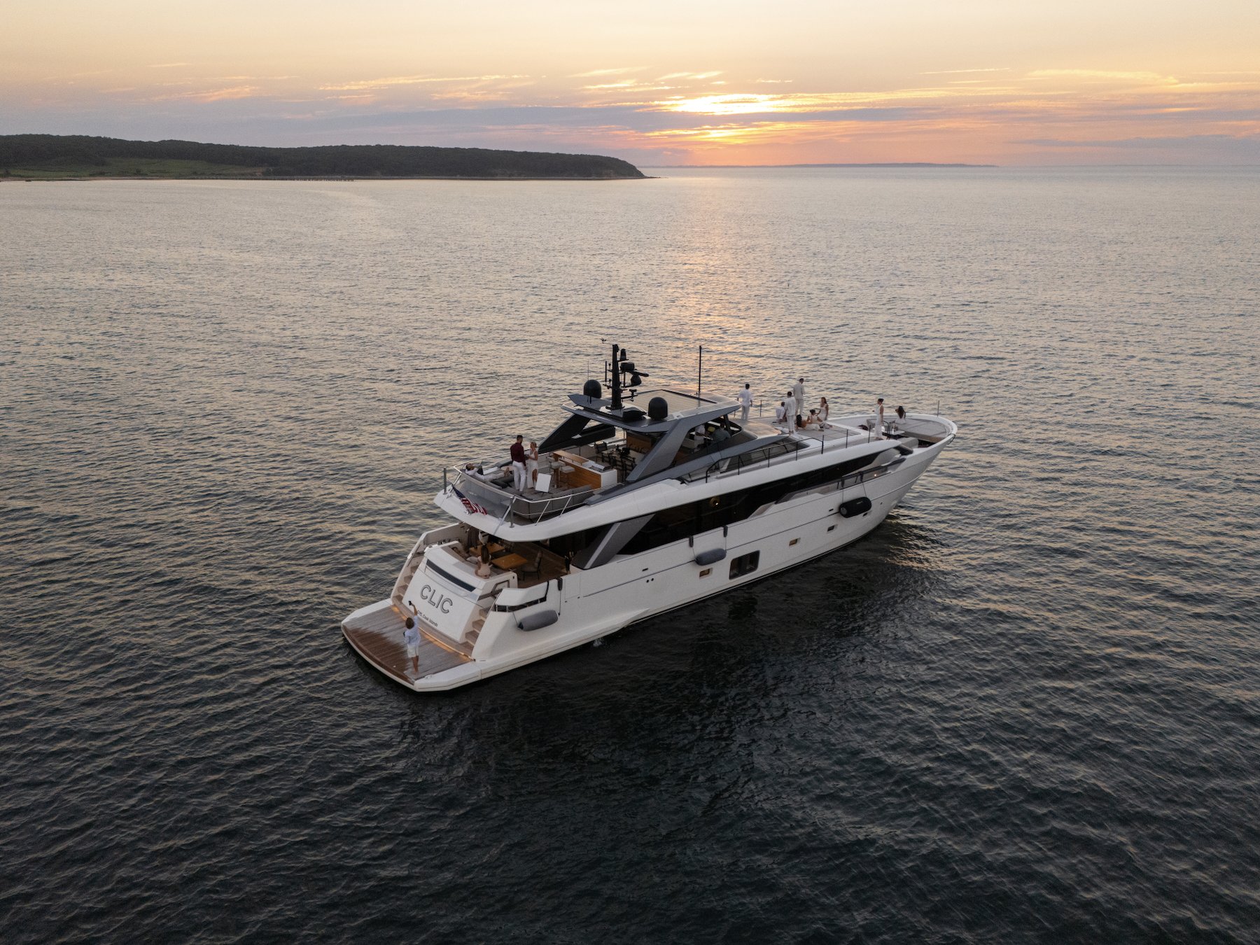 Superyacht underway at sunset
